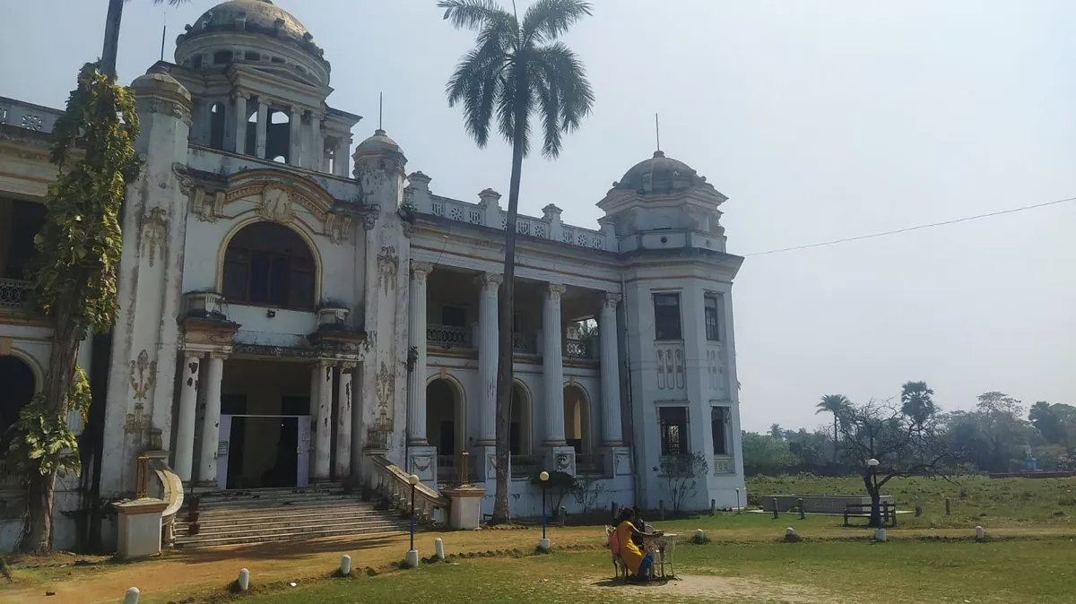 Old colonial rajbari with palm trees in front